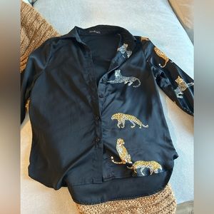 Long sleeve satin button up shirt. Half of the shirt has cheetahs.